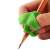 Green silicone pencil grip for kids, helps with handwriting