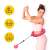 Woman using pink weighted hula hoop with massage balls, for waist and core workout, easy to assemble, quick release system
