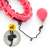 Close-up of the quick release system on the pink weighted hula hoop with massage balls