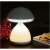 White mushroom shaped LED touch lamp with 7 color changing lights turned on