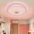 Bluetooth ceiling light with RGB color and speaker, controlled by remote and smartphone, installed in a bedroom