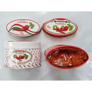 Two oval metal tins of paprika, one red and one white, both with polka dots and a red chili pepper design, with the lids off showing the paprika inside