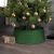 Green plastic Christmas tree base cover in living room setting