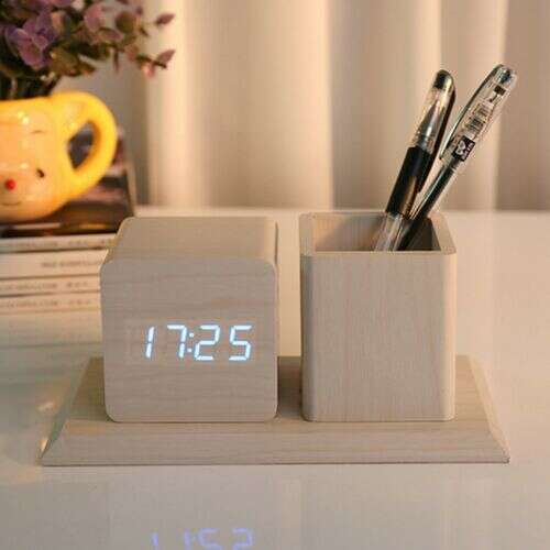 Light brown wooden desk clock and pen holder with digital display showing 17:25