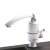 Instant electric water heater faucet, white, installed on a kitchen sink