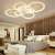 Modern LED ceiling light fixture with six circular rings, installed in a bedroom