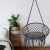 Pepita grey macrame hanging chair in a bedroom