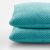 Close-up of two Decoking HENRY turquoise embossed cushion covers