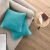 Decoking HENRY turquoise cushion covers on a modern sofa