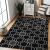 Hakano WINK HEXAGON black rug in a living room setting
