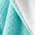 Close-up of AmeliaHome SHLEEPY turquoise and white embossed blanket texture