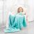 Girl relaxing with AmeliaHome SHLEEPY turquoise blanket in hanging chair