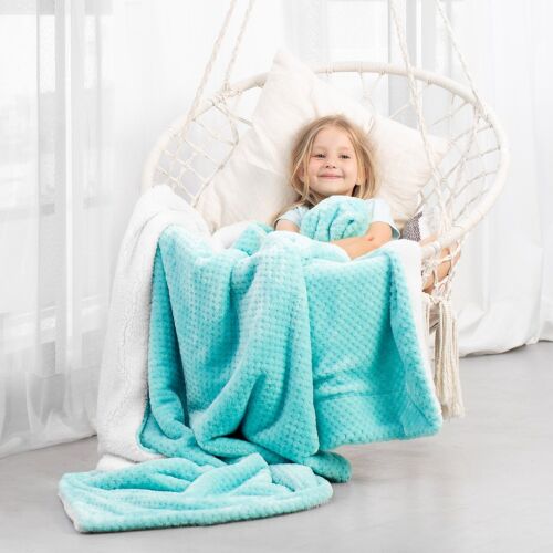Little girl wrapped in a turquoise SHLEEPY blanket sitting in a hanging chair