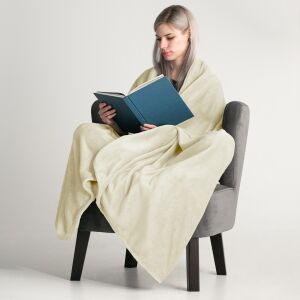 Woman wrapped in DecoKing MIC Cream Microfiber Blanket reading a book - Blanket