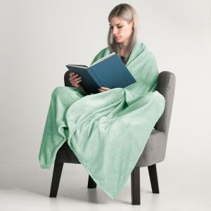Woman wrapped in DecoKing MIC mint green microfiber blanket reading a book - Blanket
