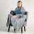 Woman wrapped in a DecoKing MIC grey microfiber blanket reading a book