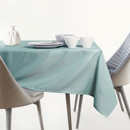 Ovalni stolnjak AmeliaHome Empire boje mente na stolu za blagovanje.