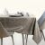 AmeliaHome Gaia cappuccino tablecloth on a set dining table with plates and bowls.