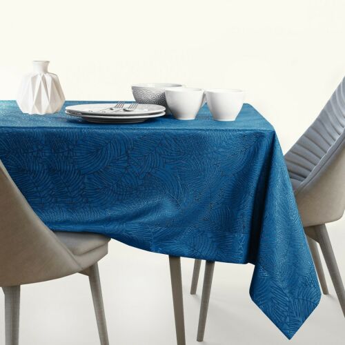 AmeliaHome Gaia indigo blue embossed tablecloth on a set table with dishes and decorations.