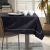 AmeliaHome Gaia black embossed tablecloth on a dining table with tableware.