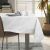 AmeliaHome Gaia white embossed tablecloth on dining table with tableware