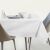 Elegant AmeliaHome Gaia white embossed tablecloth on dining table