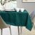 AmeliaHome Gaia glass green embossed tablecloth on a set dining table.