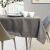 AmeliaHome Gaia brown tablecloth on a dining table with tableware.