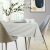 AmeliaHome Gaia cream embossed tablecloth on a set table in a room