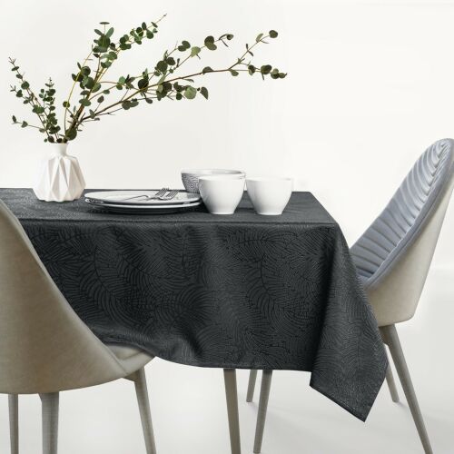 AmeliaHome Gaia graphite grey embossed oval tablecloth on a set table.