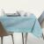AmeliaHome Gaia blue embossed square tablecloth on a set table.