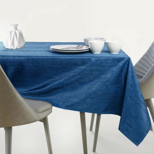 AmeliaHome Vesta indigo blue embossed oval tablecloth on a set table