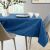 AmeliaHome Vesta Indigo Blue Embossed Oval Tablecloth on dining table setting