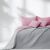AmeliaHome SOFTA pink and grey bedspread on a styled bed.