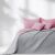 AmeliaHome SOFTA pink and grey quilted bedspread on a bed with soft lighting