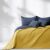 AmeliaHome SOFTA graphite grey and mustard yellow bedspread on a made bed