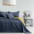 AmeliaHome SOFTA graphite grey and mustard yellow reversible bedspread on a bed with pillows