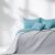 AmeliaHome SOFTA sky blue and grey reversible bedspread on a styled bed.