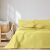 AmeliaHome Meadore yellow bedspread on a bed in a bedroom setting.