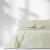 AmeliaHome Meadore cream bedspread with pom poms on a bed