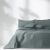 AmeliaHome Meadore grey bedspread with pom poms on a bed