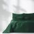 Close-up of AmeliaHome Meadore glass green bedspread on a bed
