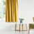 AmeliaHome mustard yellow blackout curtain in a living room setting