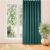 VILA teal blackout curtain hanging in front of a window