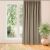 VILA beige blackout curtain hanging in front of window