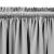 Close-up of grey blackout curtain with rod pocket and pleats.