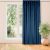 VILA indigo blue velvet blackout curtain hanging in front of a window