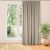 CARMENA beige blackout curtain hanging in front of window