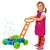 Child playing with bubble blowing lawnmower toy, blue and green, with orange handle