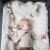 Baby sleeping with BabyOno Zoe Goose Plush and other toys